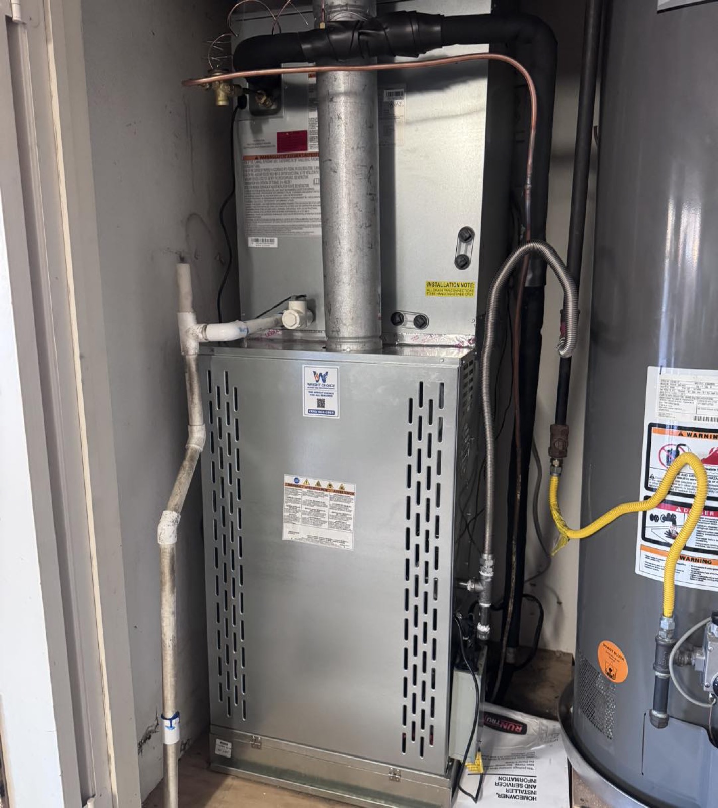 Gas furnace and coil installation with Wright Choice service tag beside a water heater in Abilene, TX
