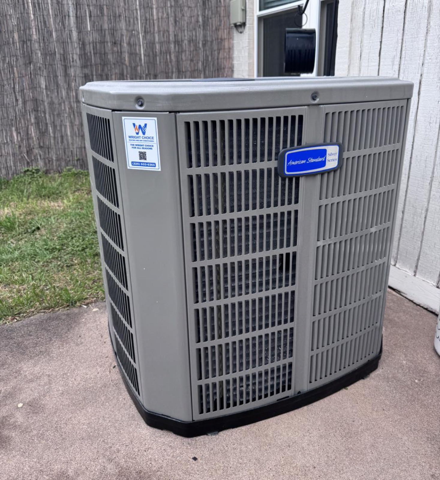 American Standard Silver Series AC condenser with a Wright Choice sticker on a back-patio pad in Abilene, TX